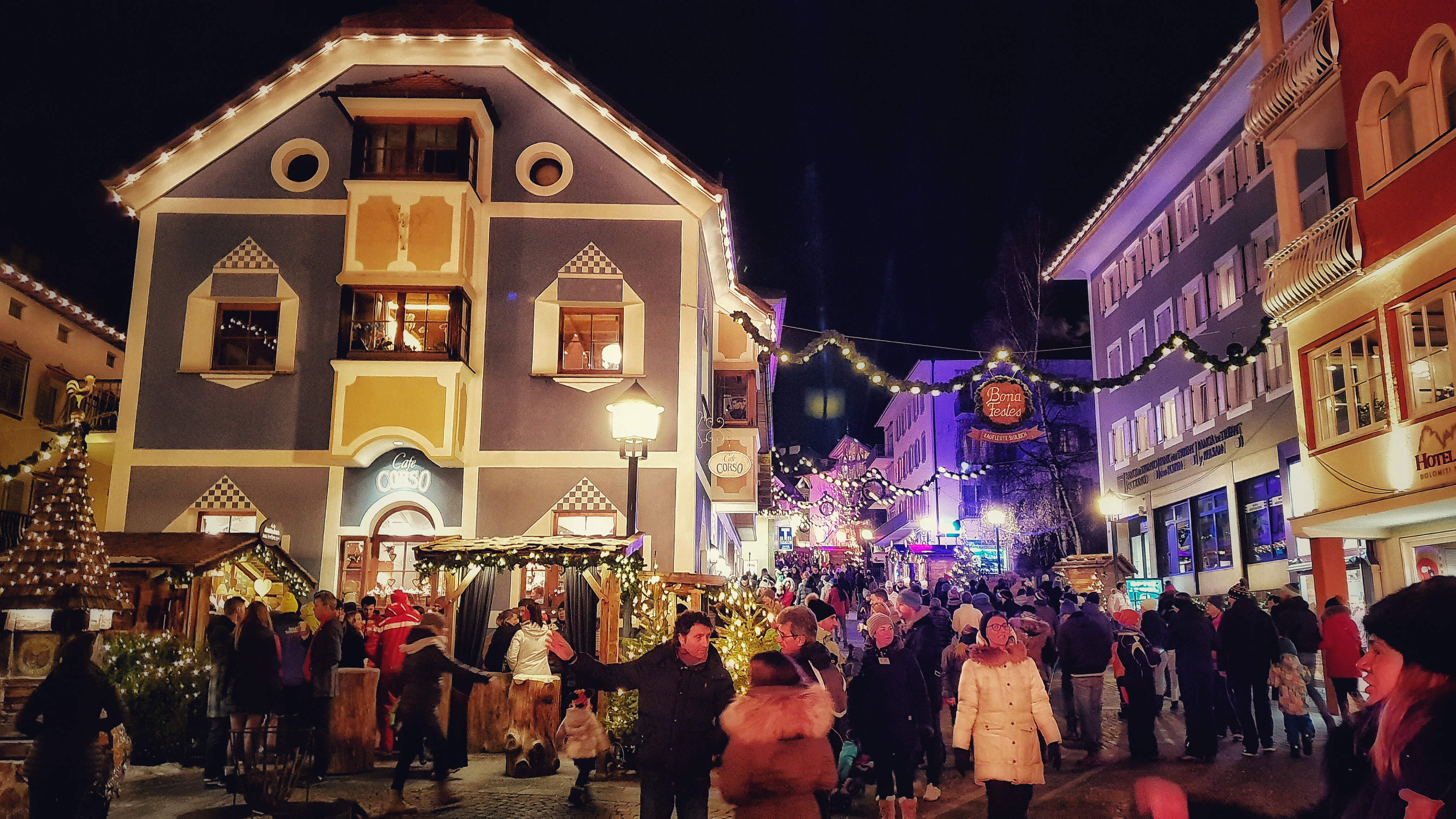 ortisei town at night with coloured lights and christmas market
