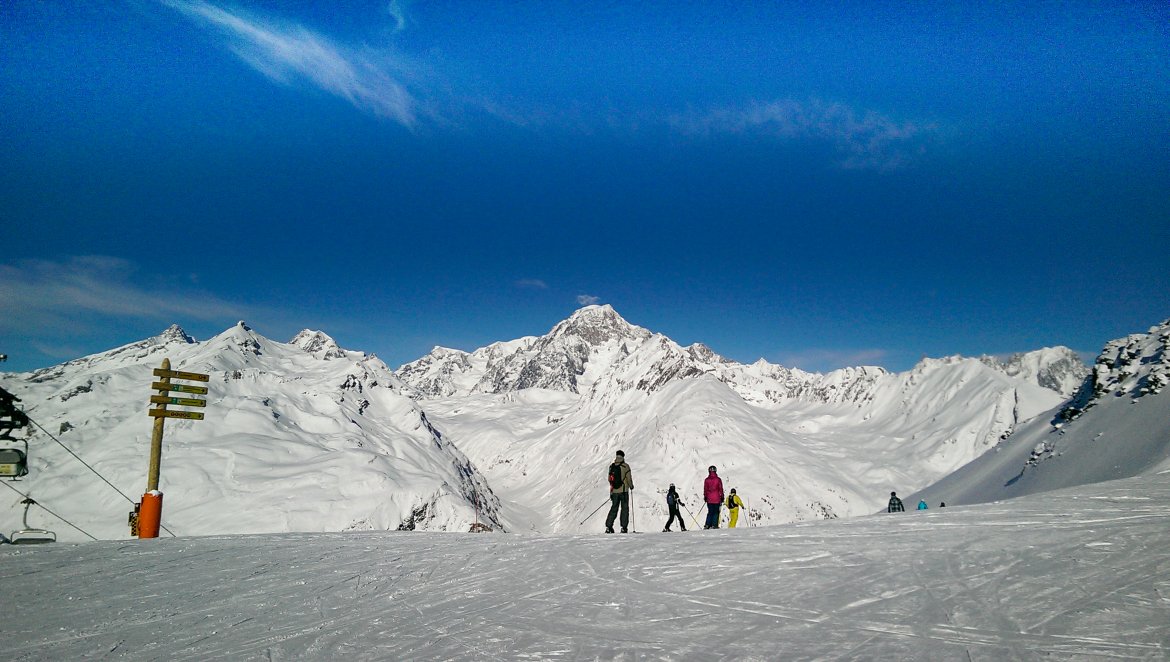 skiers looking from italy into the distance at mont blanc in france