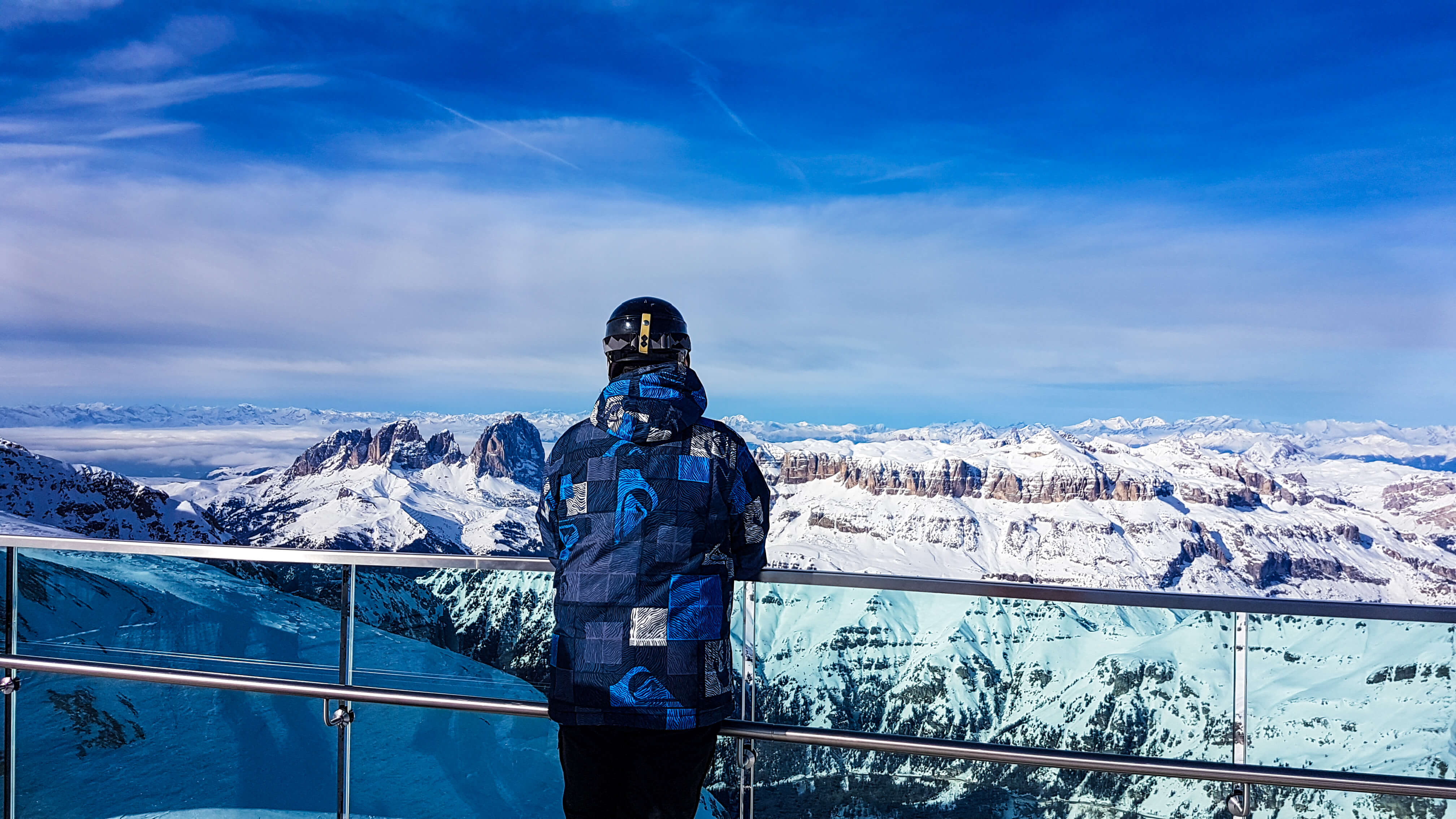skier-looking-out-to-the-sella-mountains-from-the-viewing-station-of-the-marmolada-glacier-at-3342-metres