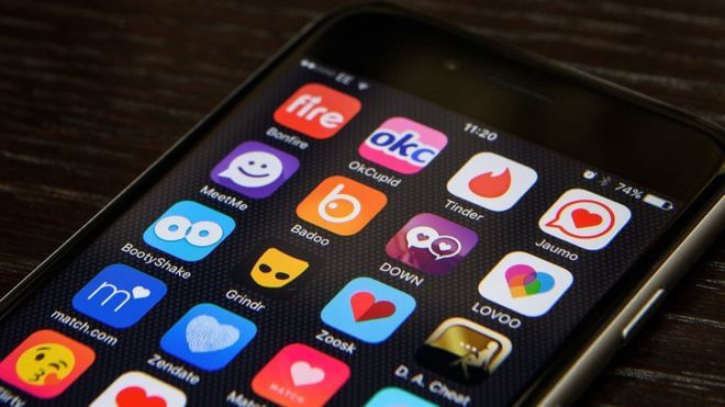 phone in closeup showing all the different dating app icons