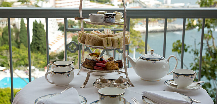 sanwich three tea platter teapot and teacups ready for afternoon tea at belmond reid's palace