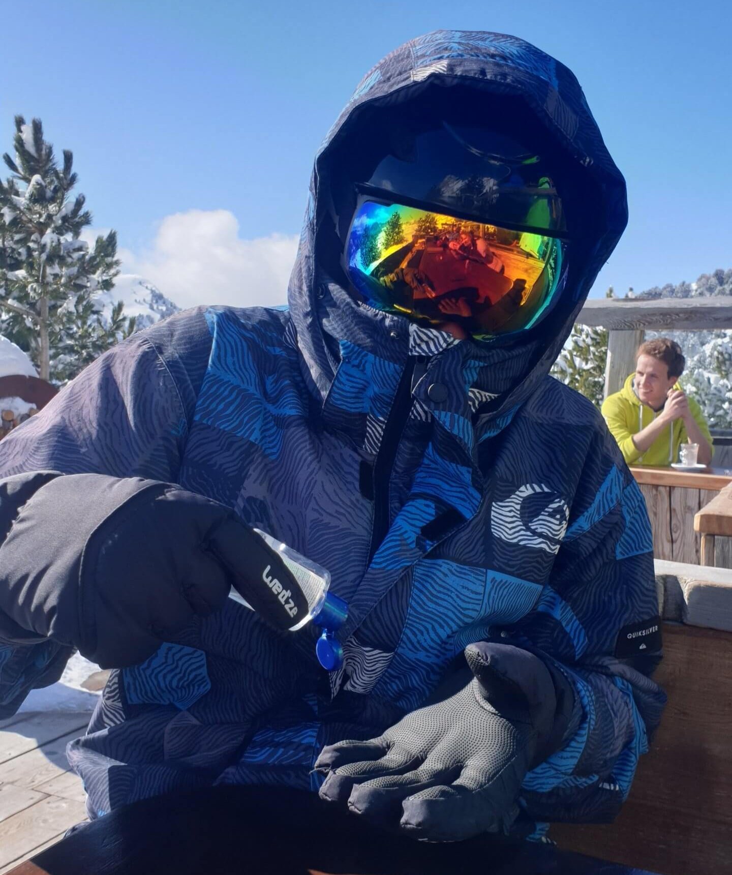 man squeezing hand gel in full ski gear fighting against coronavirus in italy